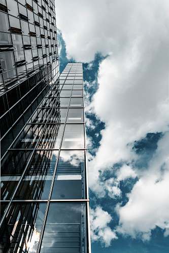 office building gray and clear glass building during day sky